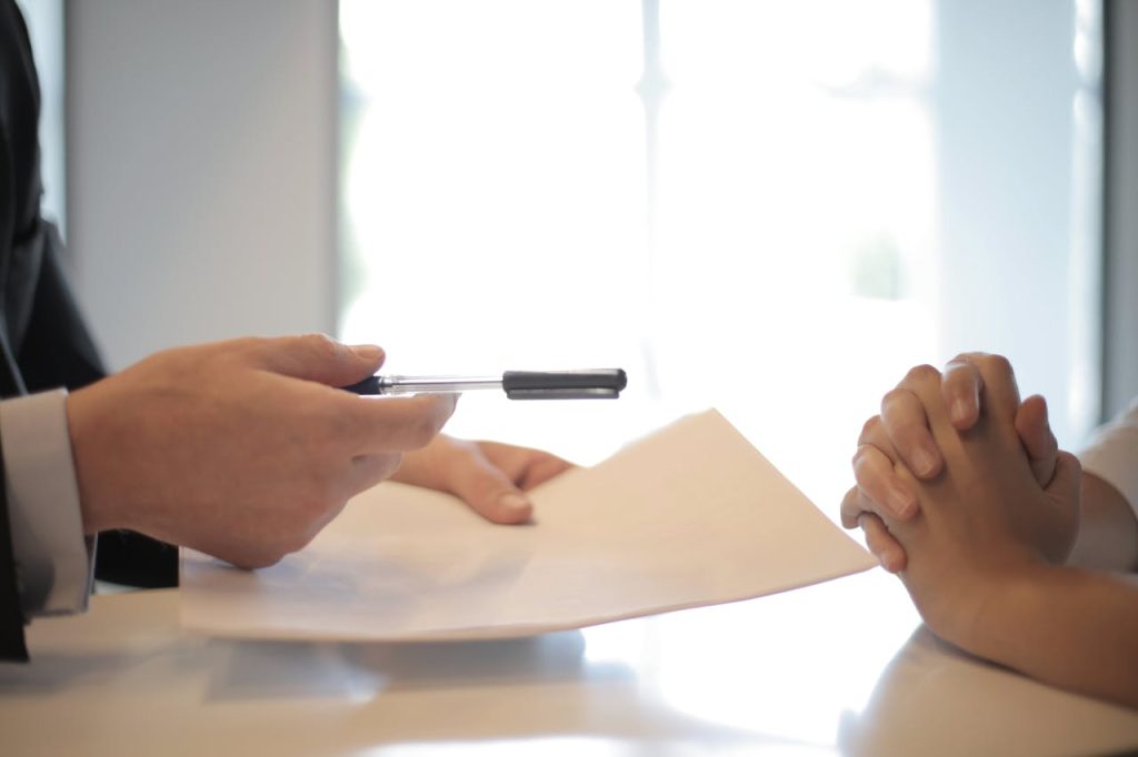 crop-businessman-giving-contract-to-woman-to-sign-3760067 Close-up of a contract signing with hands over documents. Professional business interaction.